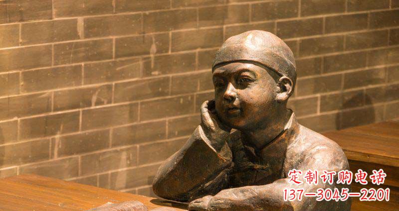 辽阳商场坐在桌前看书的小孩景观铜雕